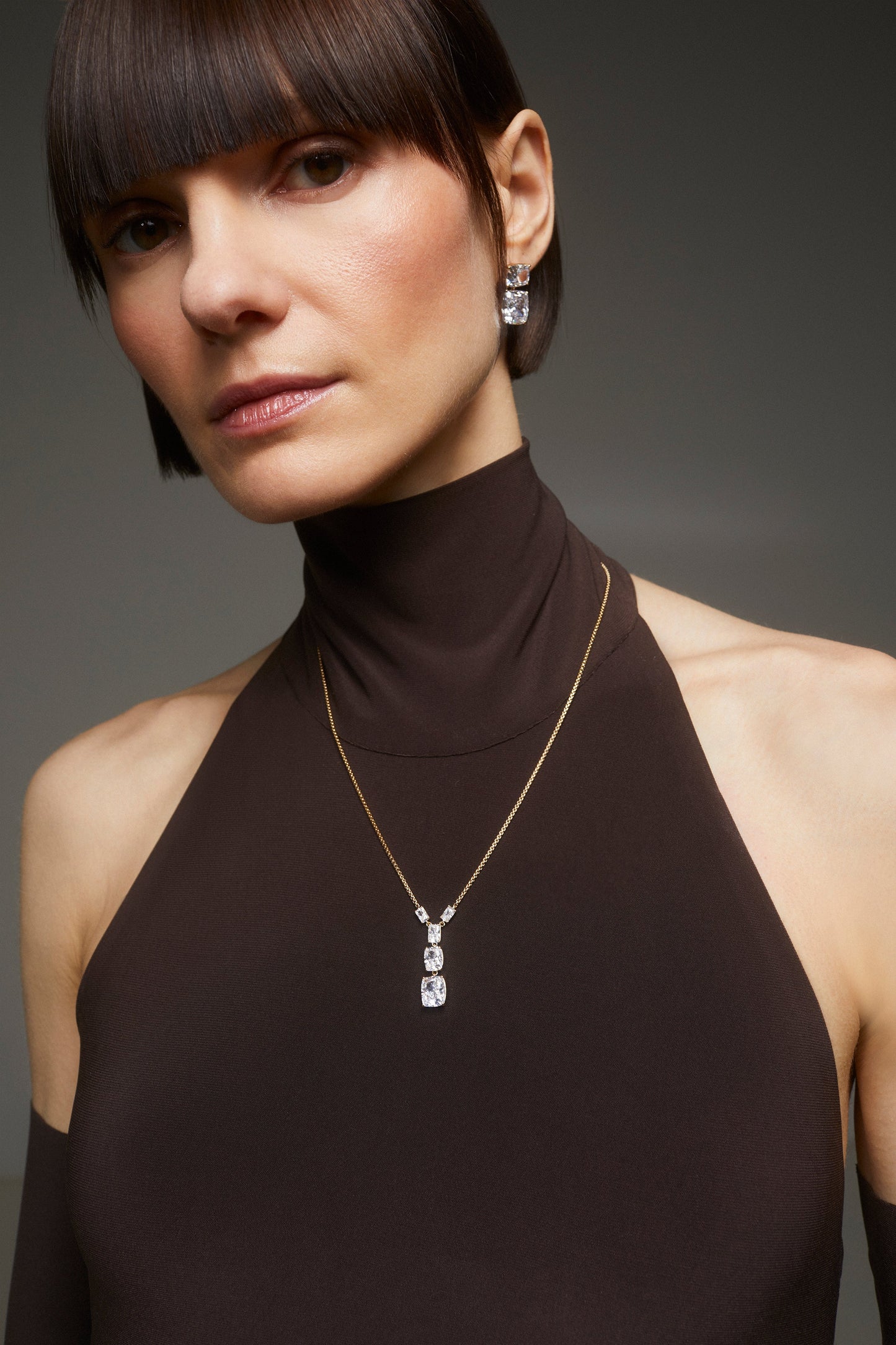 IMAGE OF MODEL WEARING THE NORTHERN LIGHTS CLEAR CZ ADJSUTABLE SMALL Y NECKLACE FOR SCALE.  SHE IS ALSO WEARING MATCHING EARRINGS.