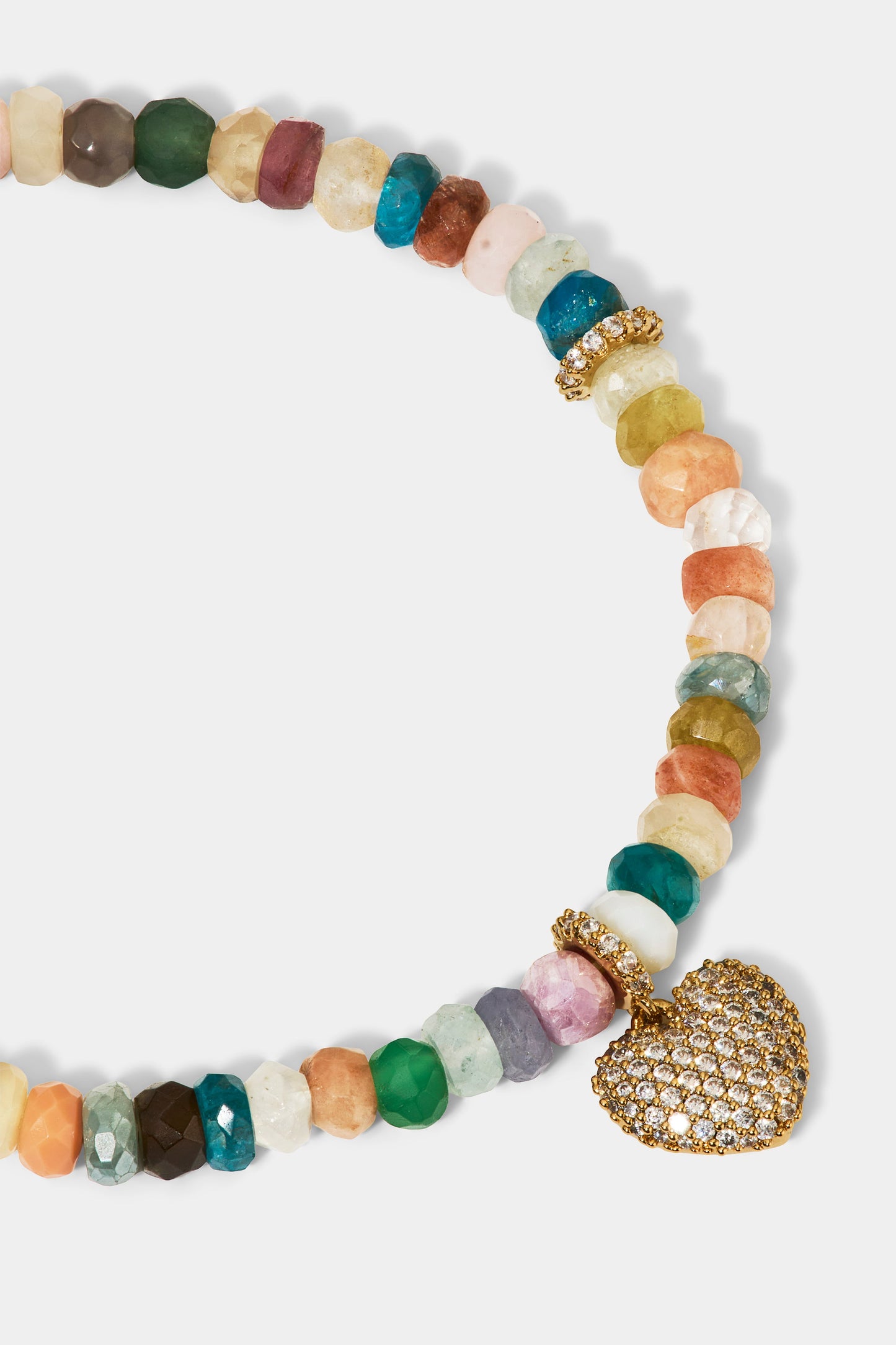 CLOSE UP OF THE HEART CHARM ON THE BEADS OF PARADISE HEART BOLO BRACELET