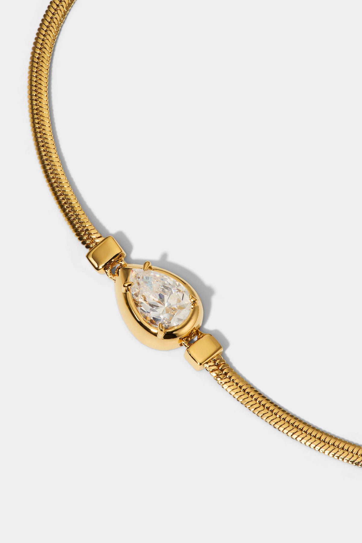 CLOSE UP OF THE PEAR ON THE DELANCEY PEAR LINE BRACELET IN GOLD PLATING