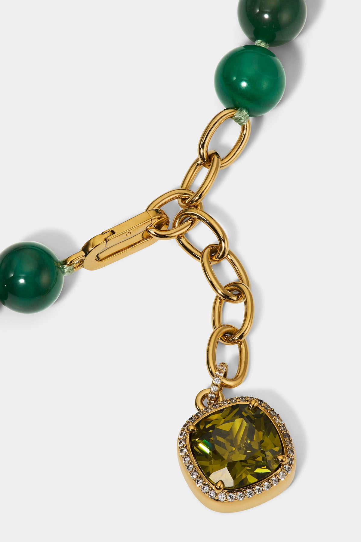 CLOSE UP OF THE CUSHION CHARM ON THE BEADS OF PARADISE GREEN ADJUSTABLE Y NECKLACE