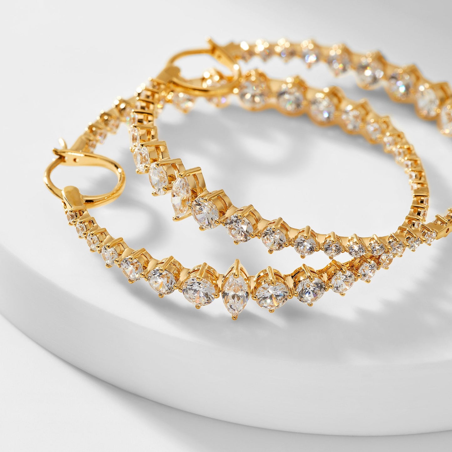 IMAGE OF LEAH STATEMENT HOOP EARRINGS LAYING ON THEIR SIDE TO SHOW CLOSE UP OF STONE DETAILS.