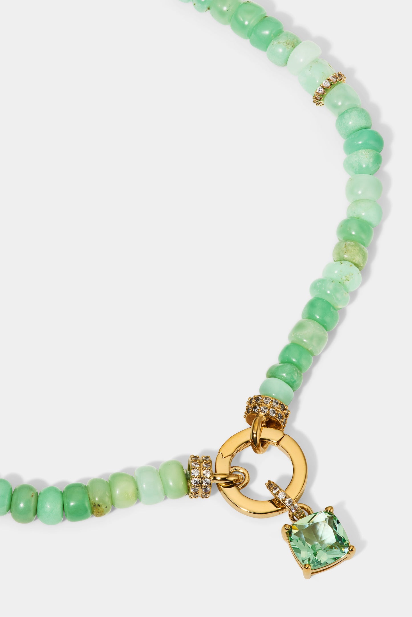 CLOSE UP OF THE CUSHION CHARM ON THE BEADS OF PARADISE GREEN CUSHION PENDANT NECKLACE