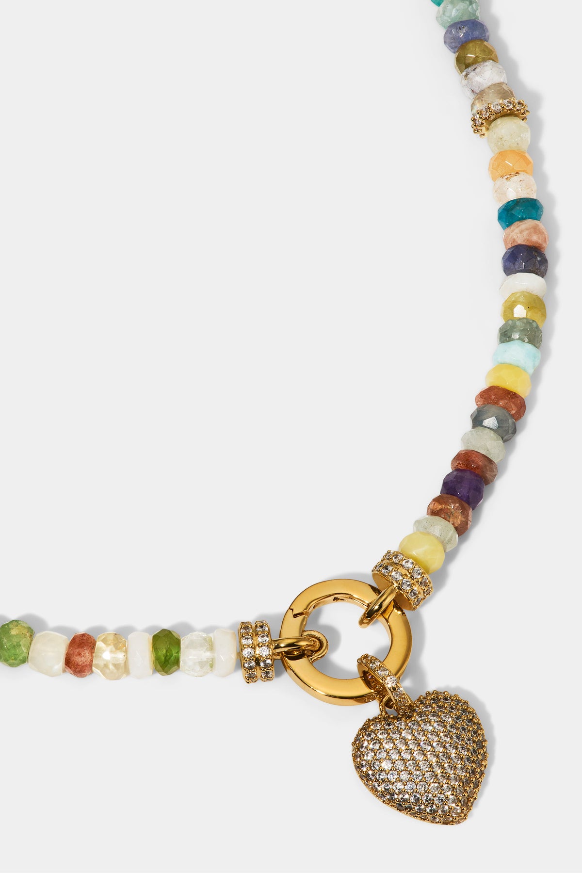 CLOSE UP OF THE HEART CHARM ON THE BEADS OF PARADISE SMALL HEART PENDANT NECKLACE