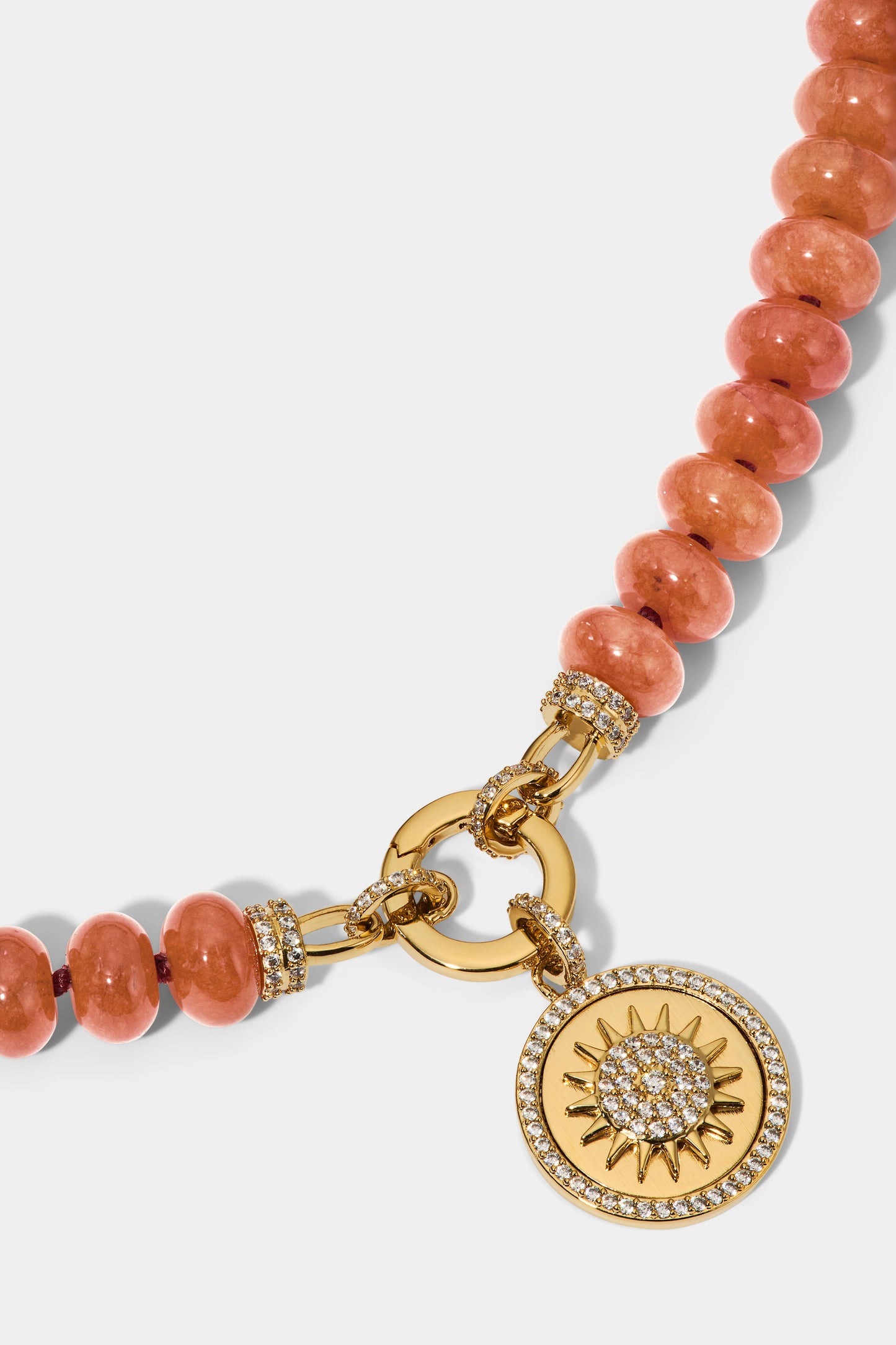 CLOSE UP OF THE SUN PENDANT ON THE BEADS OF PARADISE SUN PENDANT NECKLACE