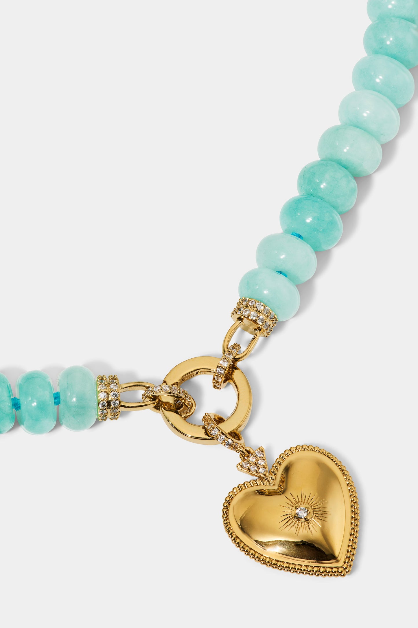 CLOSE UP OF THE HEART PENDANT ON THE BEADS OF PARADISE HEART PENDANT NECKLACE