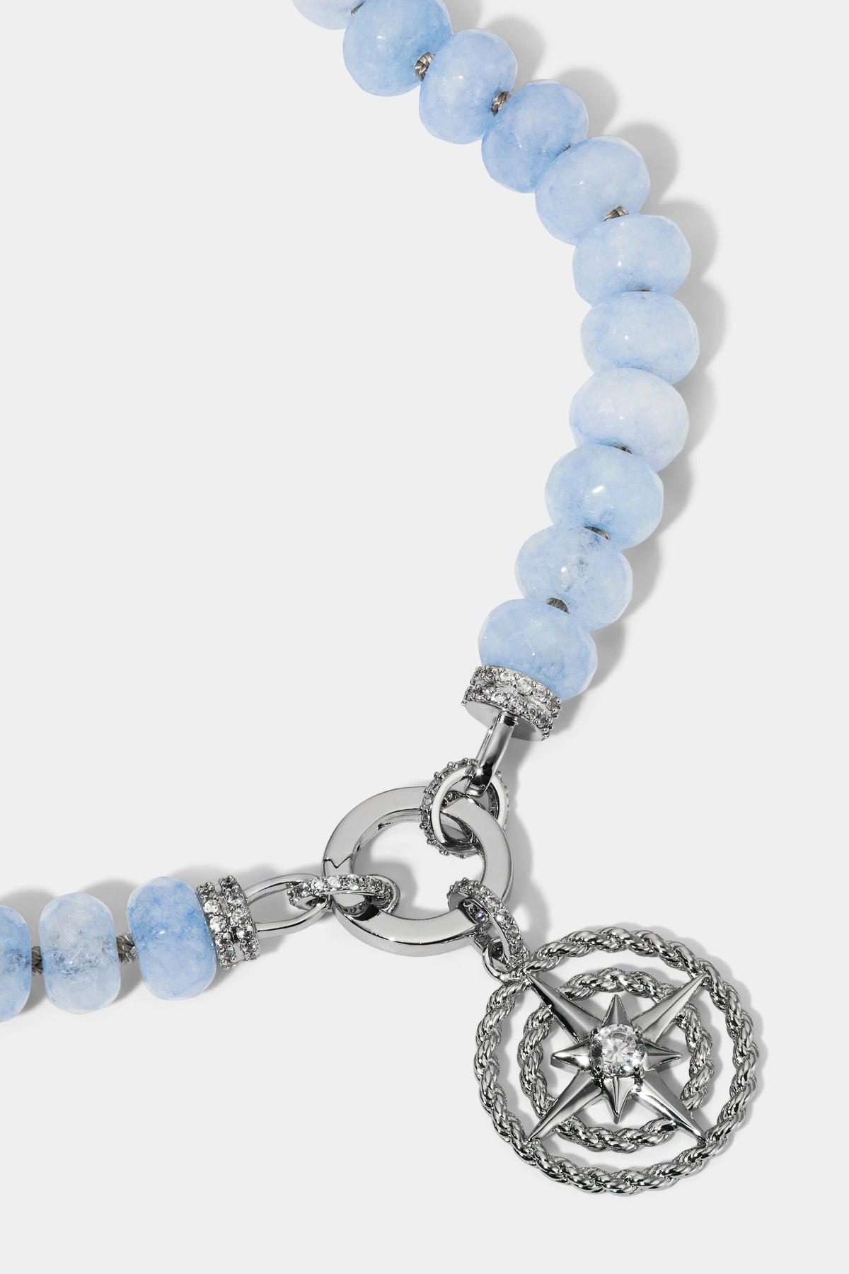 CLOSE UP OF THE MEDALLION ON THE BEADS OF PARADISE NAUT PENDANT NECKLACE