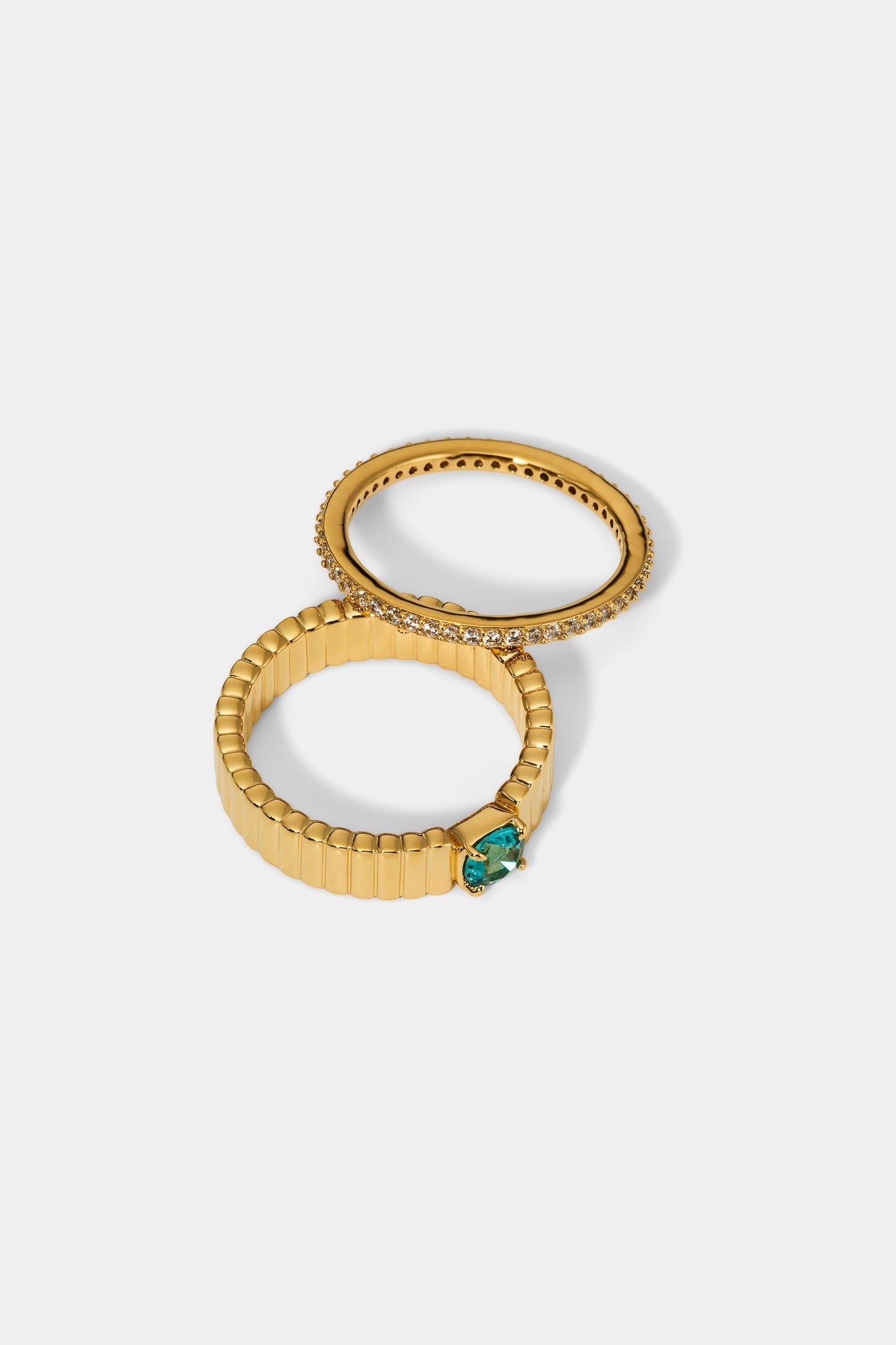 DELANCEY AQUA SOLITAIRE RING IN GOLD PLATING, SEPARATED TO SHOW OFF THE SEPARATE RINGS 