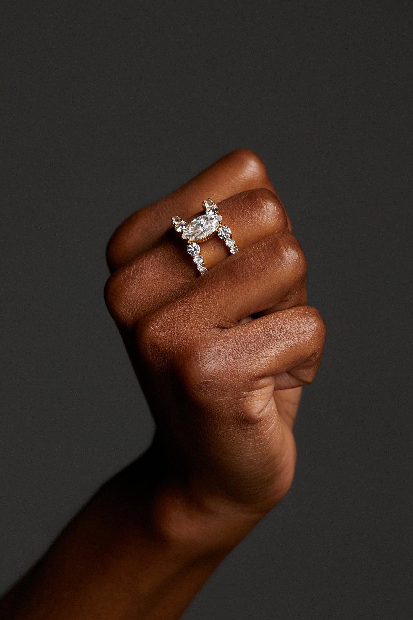 CLOSE UP IMAGE OF MODELS HAND IN A FIST WEARING THE EVERLEIGH OPEN RING