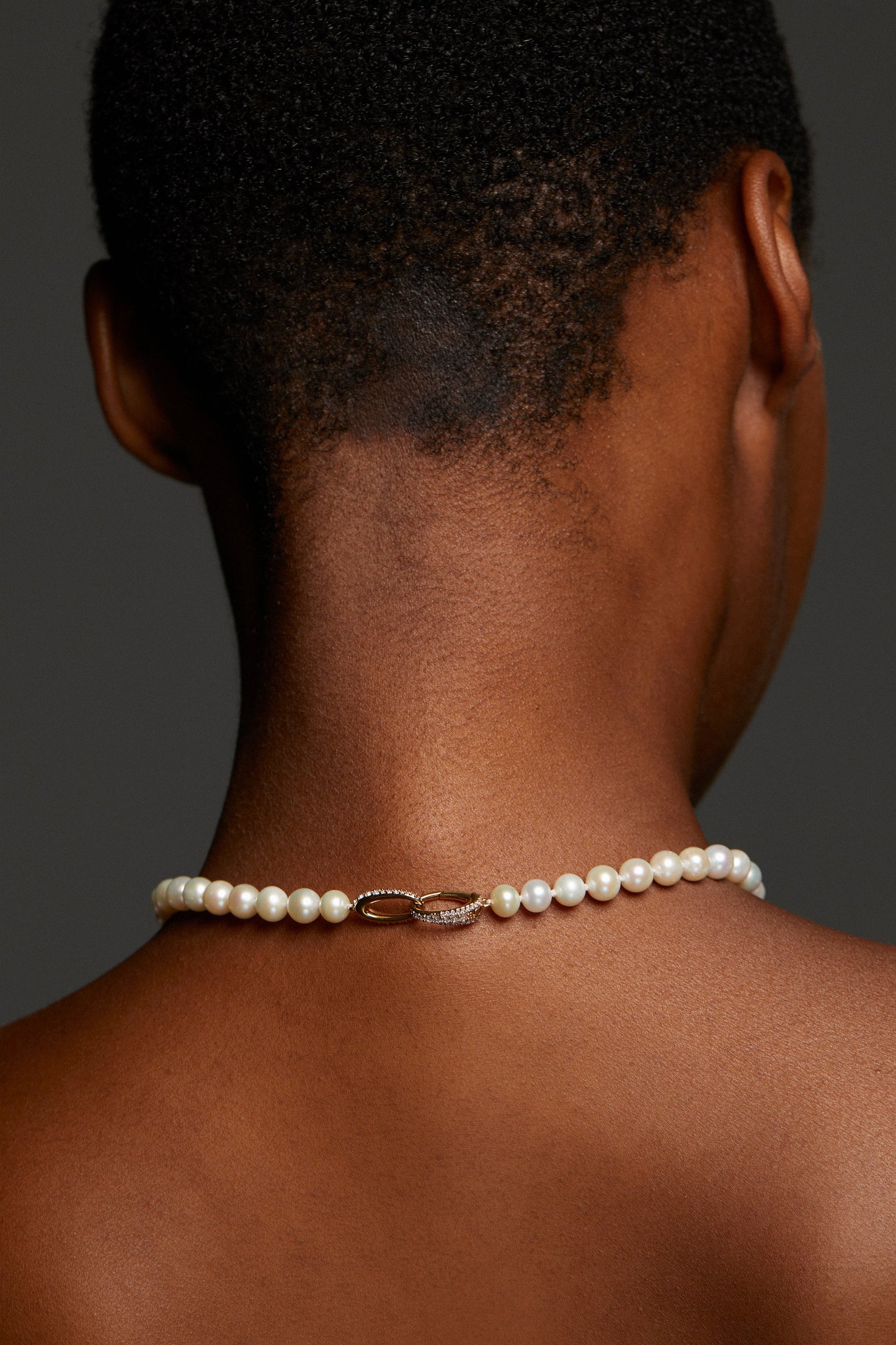 BACK VIEW OF MODEL'S NECK SHOWING CLASP DETAIL ON POPPY CASCADE Y NECKLACE