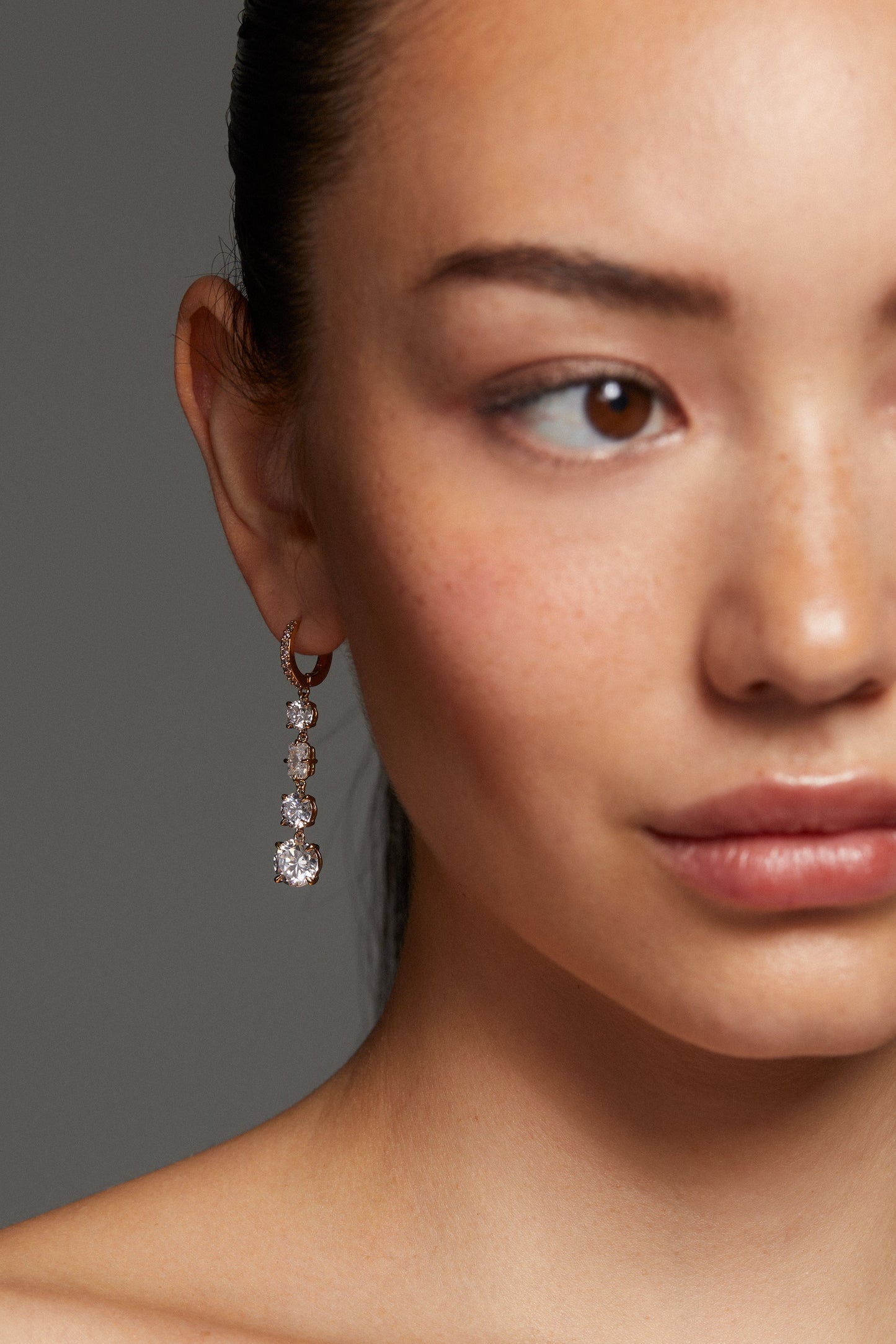 CLOSE UP ON MODEL WEARING STELLAR CZ LINEAR LEVERBACK EARRINGS