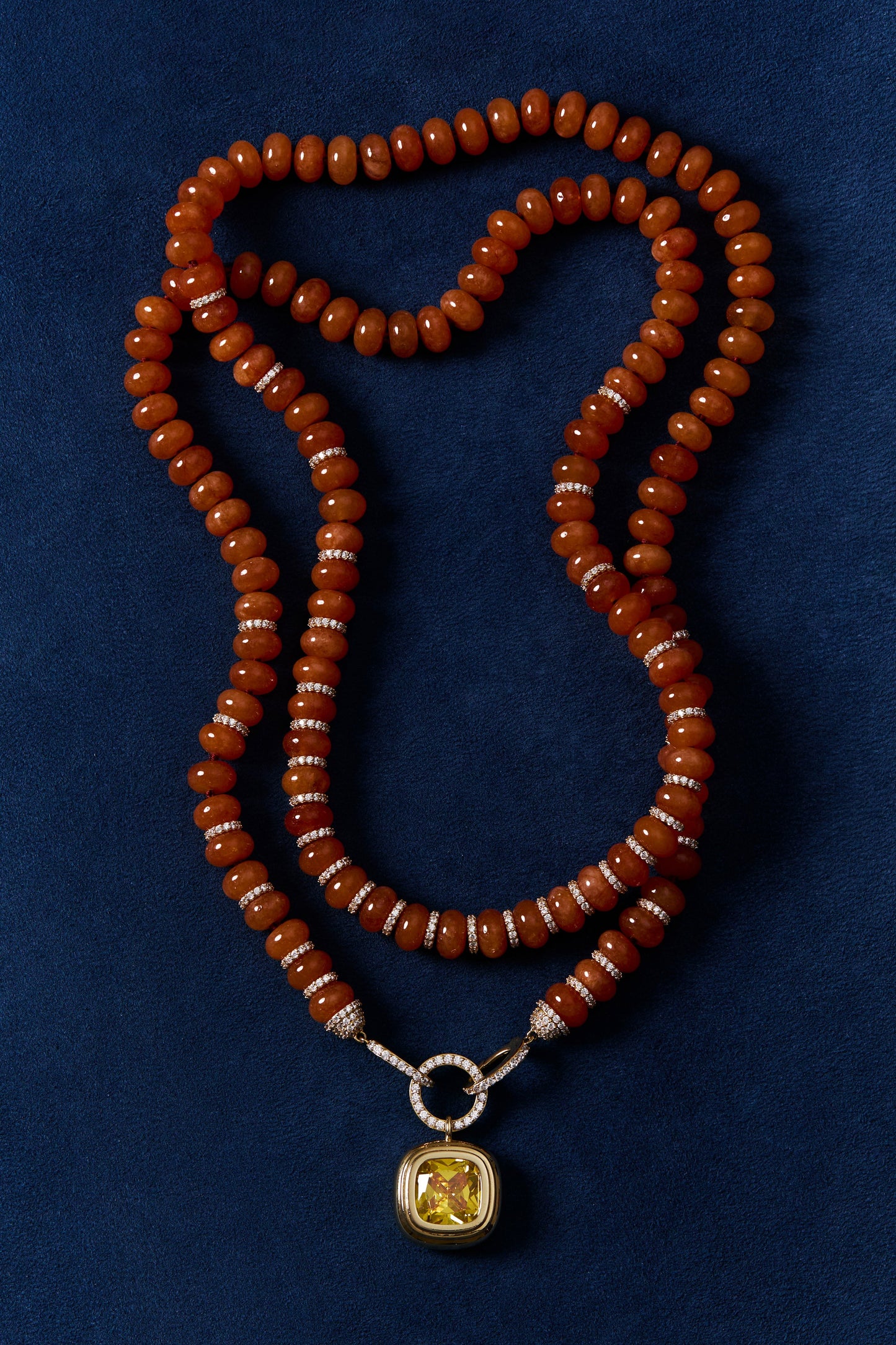 BOUJEE BEADS CARNELIAN LARGE NECKLACE LAID OUT AGAINST A BLUE BACKGROUND