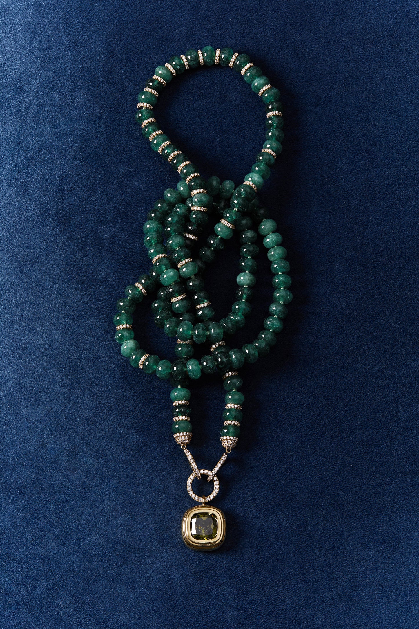 BOUJEE BEADS GREEN LONG NECKLACE WRAPPED UP AGAINST A BLUE BACKGROUND