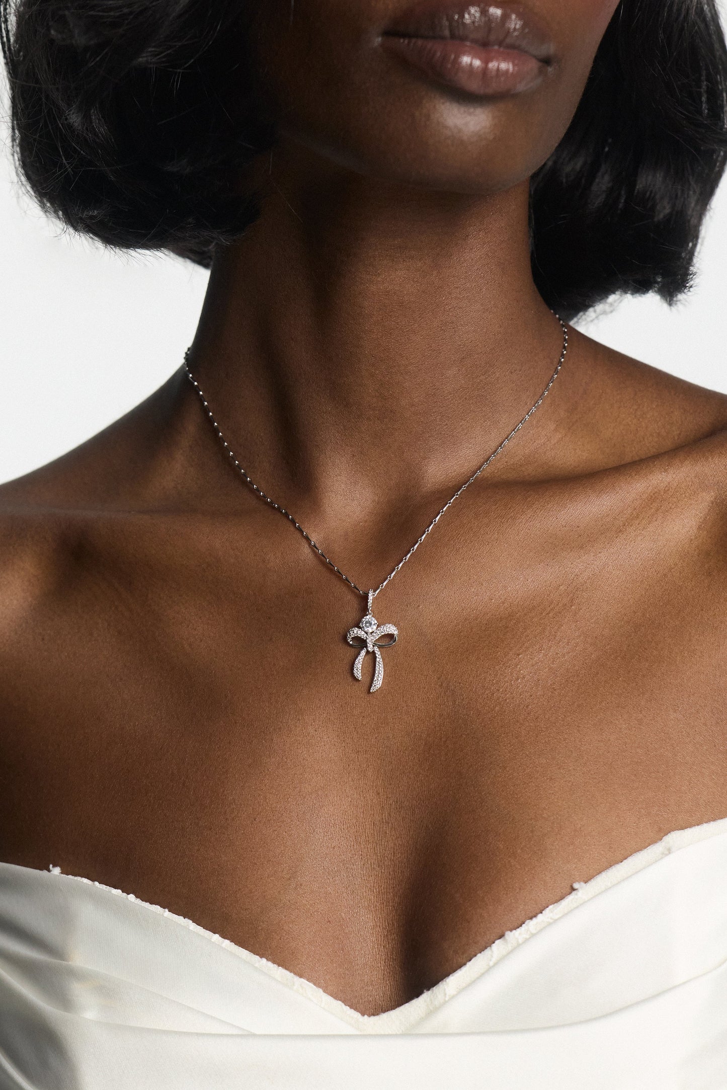 EROS BOW AND CZ PENDANT NECKLACE