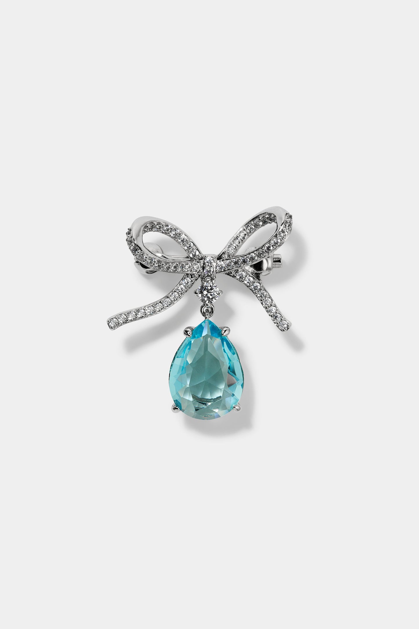 CEREMONY SWAG AQUA BOW PIN BAG CHARM IN RHODIUM PLATING