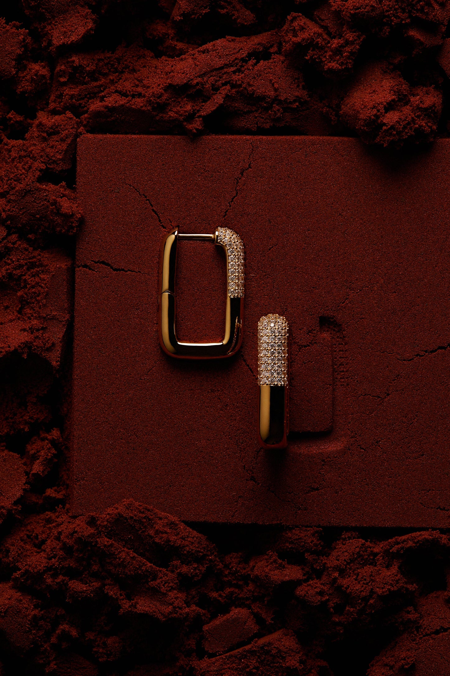 EDITORIAL STILL OF ALMA SQUARE HOOP EARRINGS ON RED SAND
