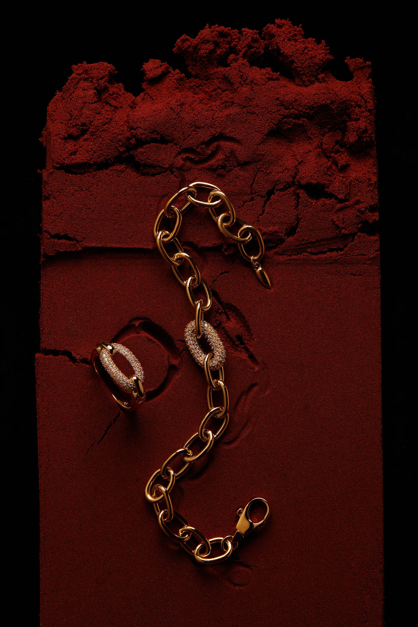 EDITORIAL STILL OF ALMA SINGLE PAVE LINK BRACELET AND RING ON RED SAND