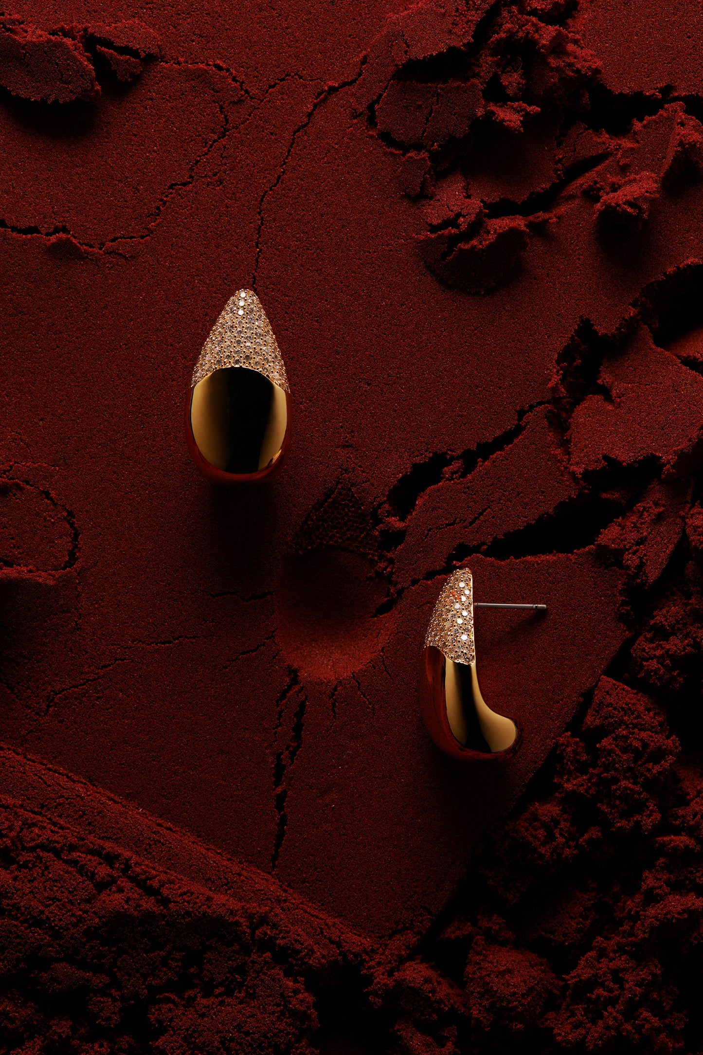 EDITORIAL STILL OF ALMA TEARDROP EARRINGS ON RED SAND