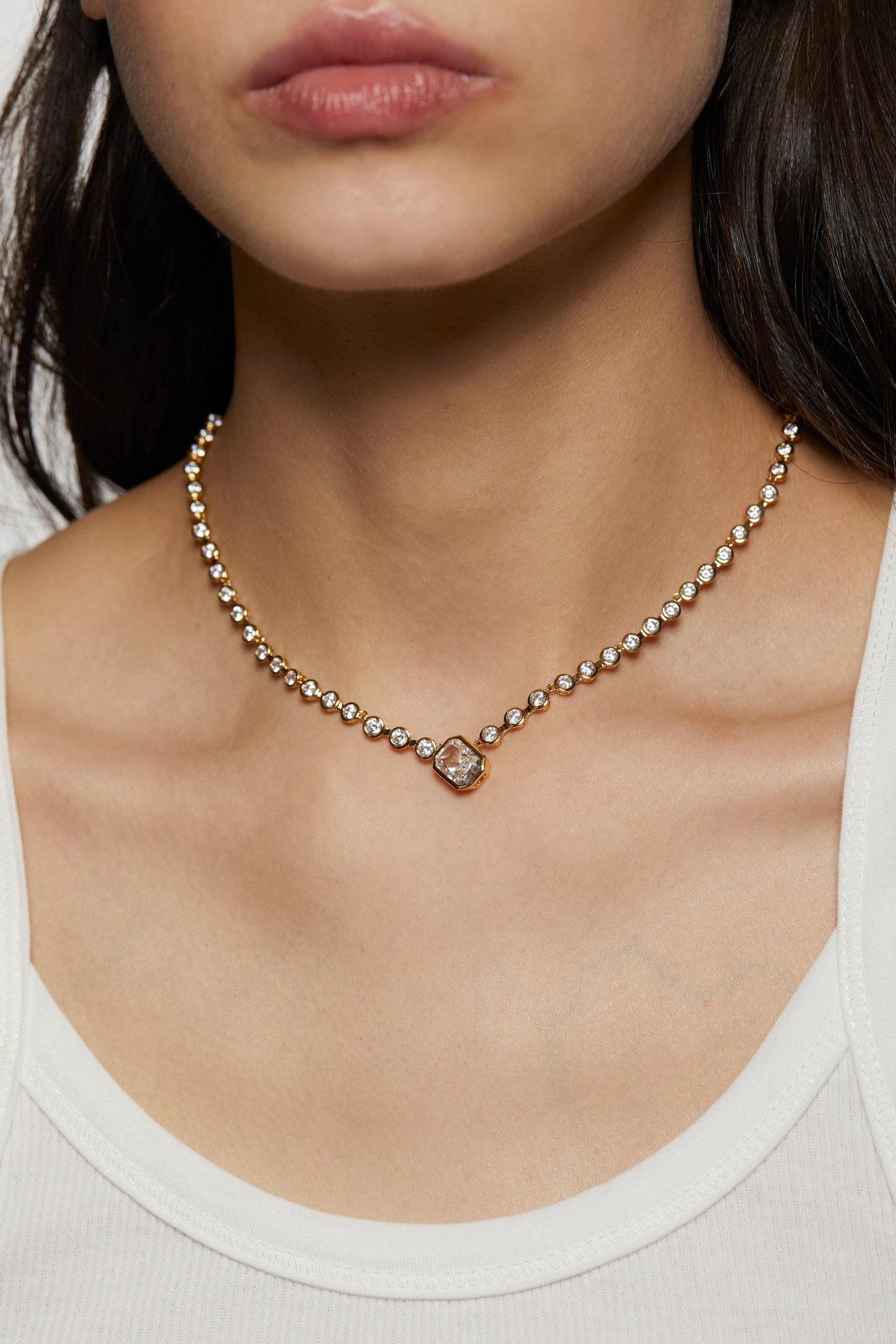 Necklace with a pendant worn by a model, focusing on the jewelry.