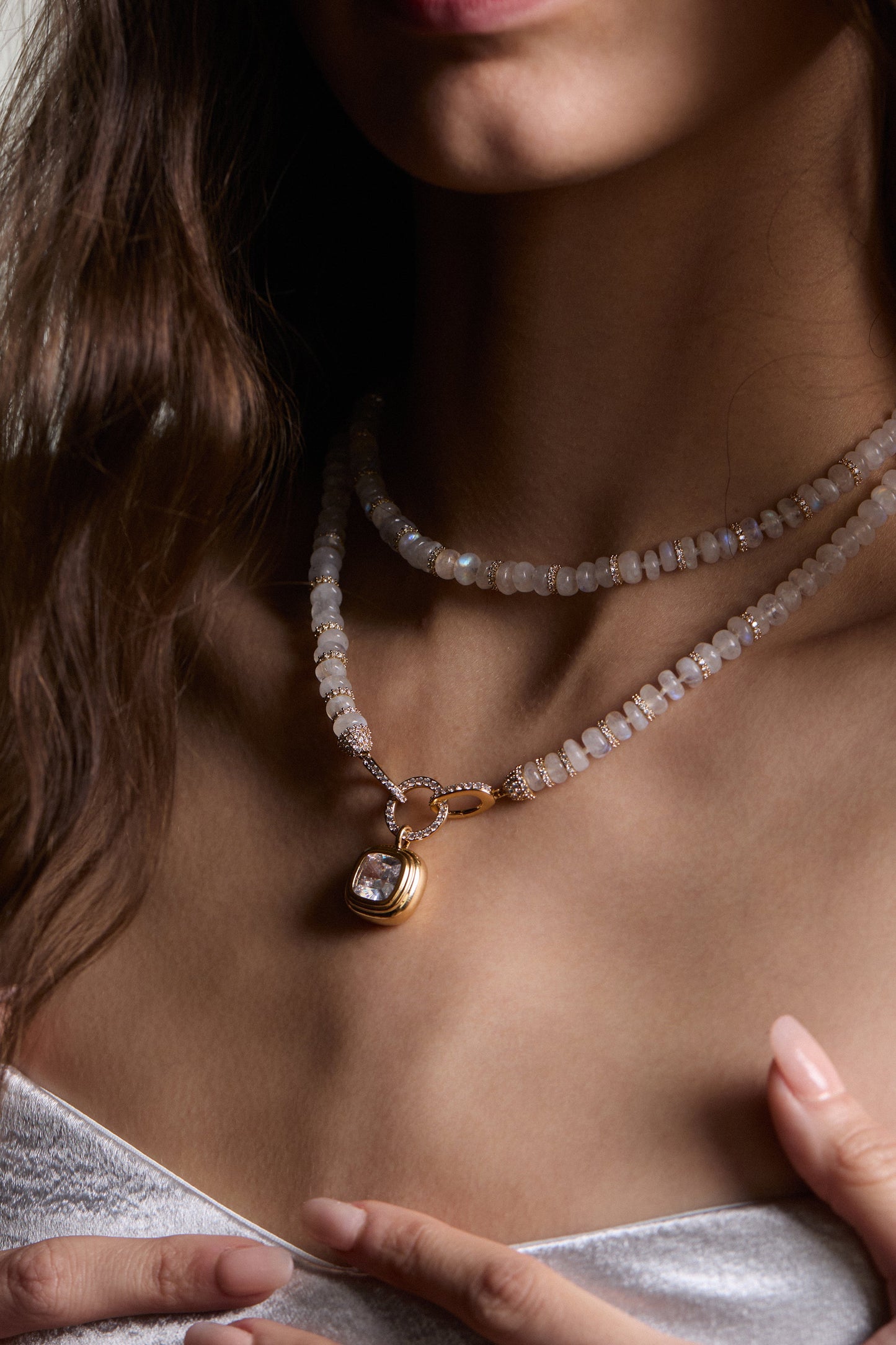 Close-up of model wearing a moonstone beaded necklace with a CZ pendant.