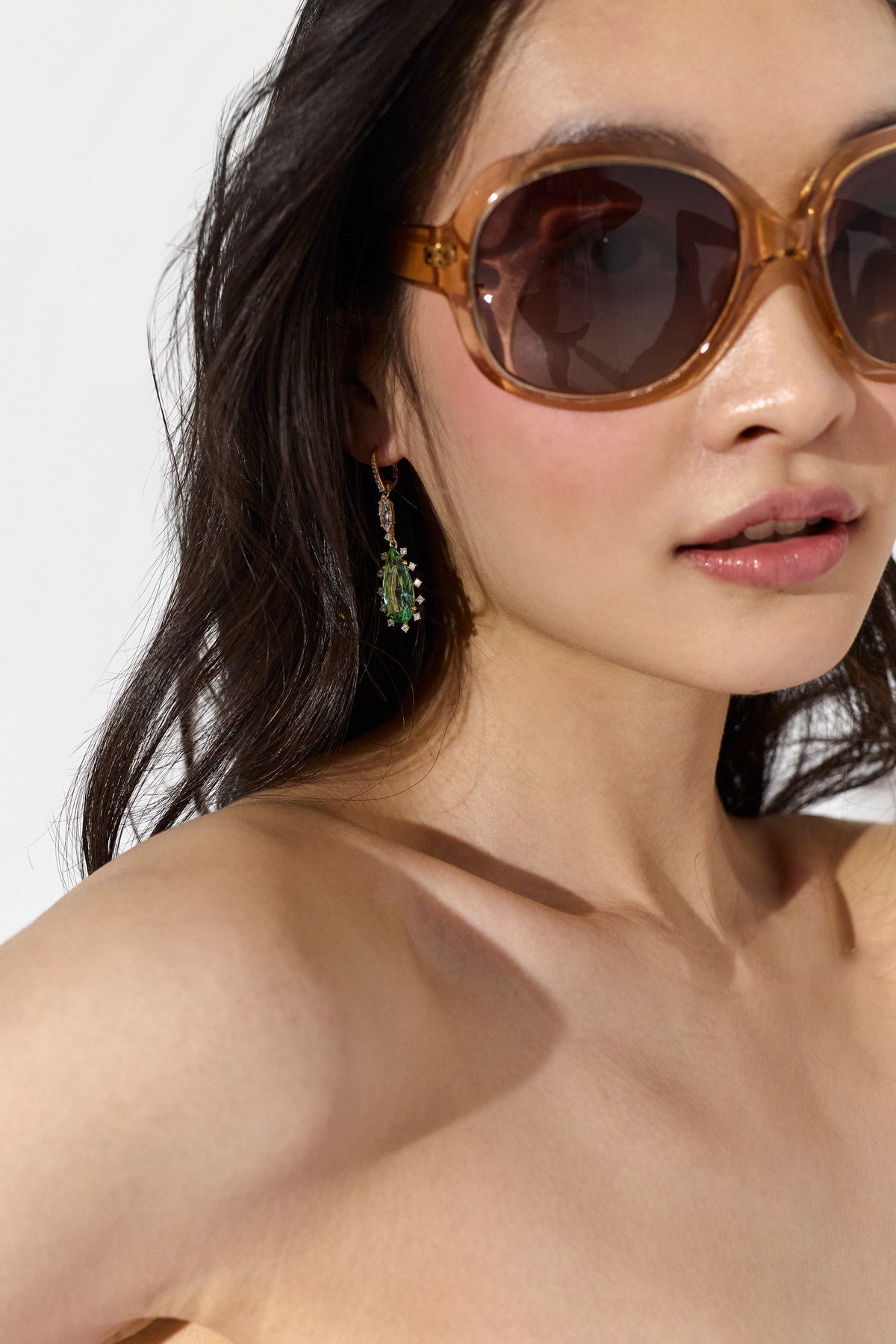 A MODEL IN SUNGLASSES WEARING NADRI'S MOJITO MINT PEAR DROP EARRINGS