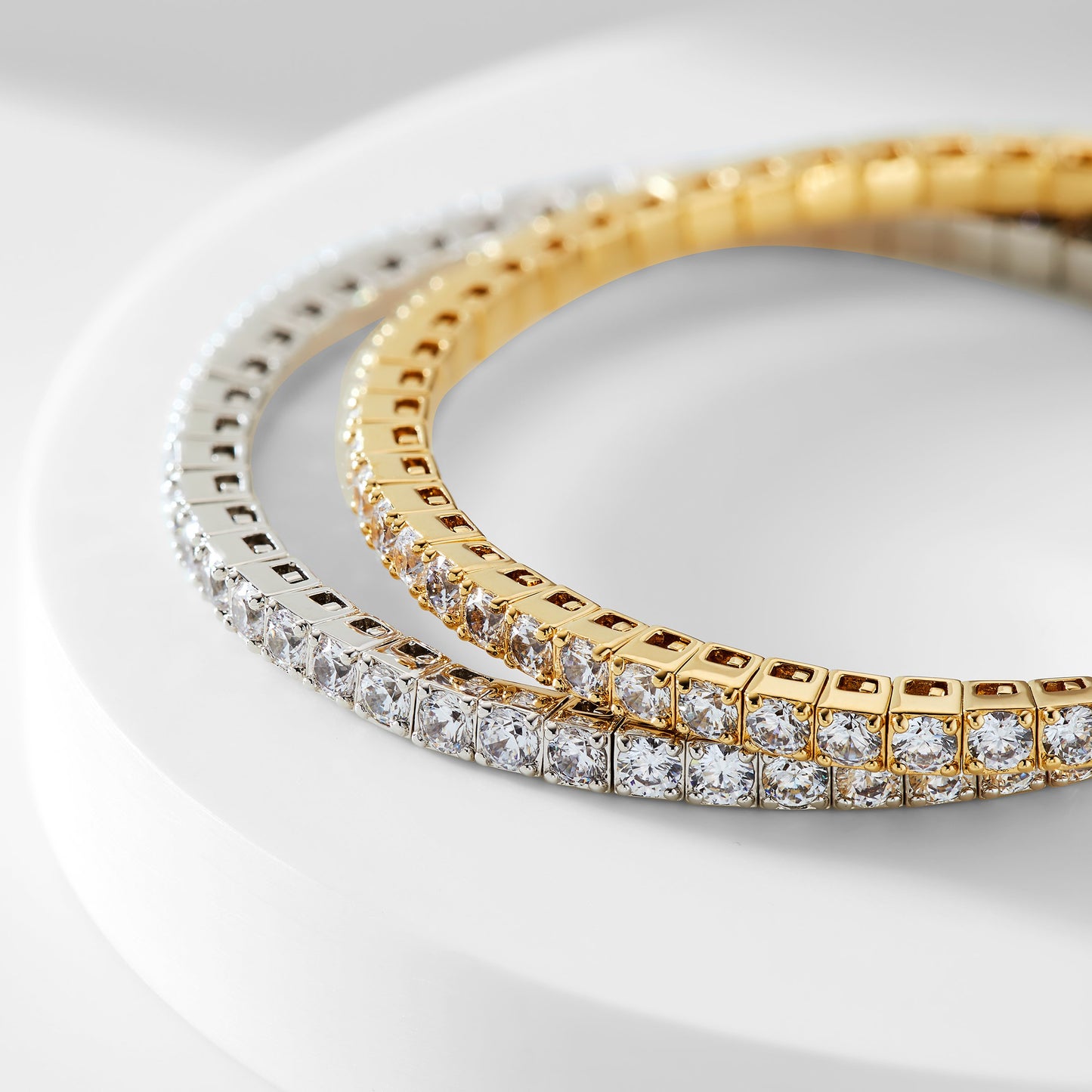 two tennis stretch bracelets with cubic zirconia stones stacked on top of one another